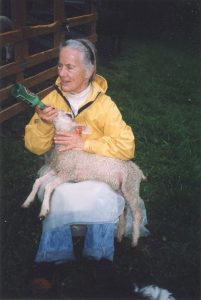 Anne Priest with bottle lamb at home in New York State